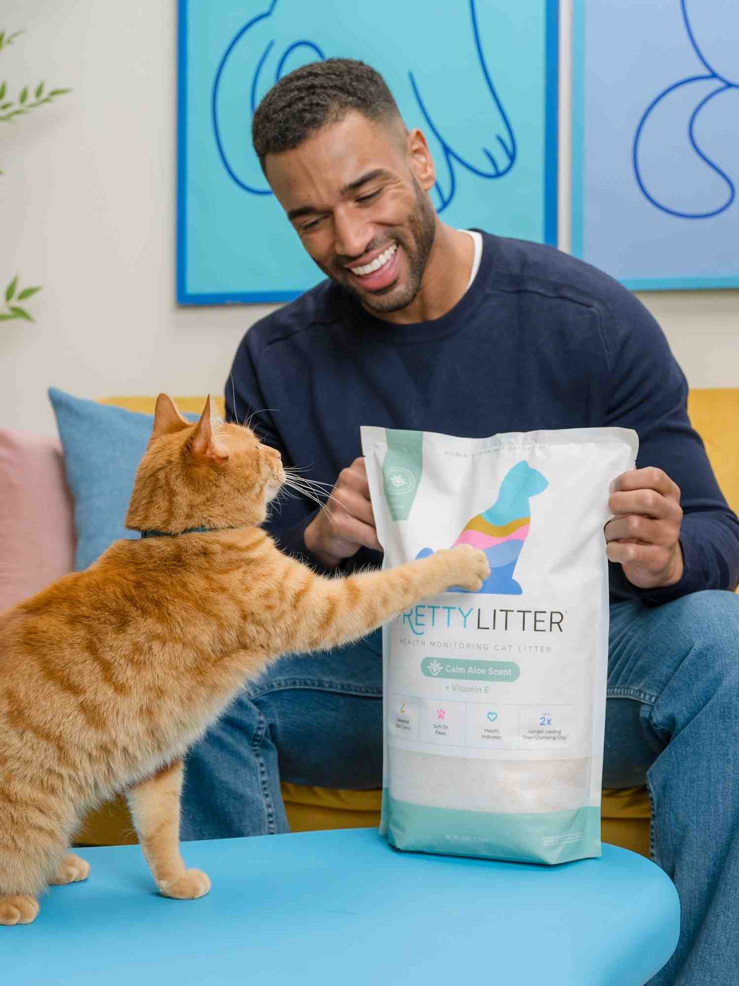 Man and cat with a bag of kitty litter