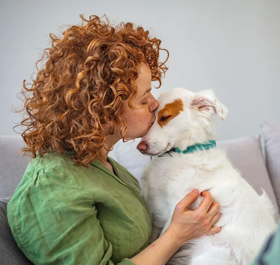 A woman kissing her dog