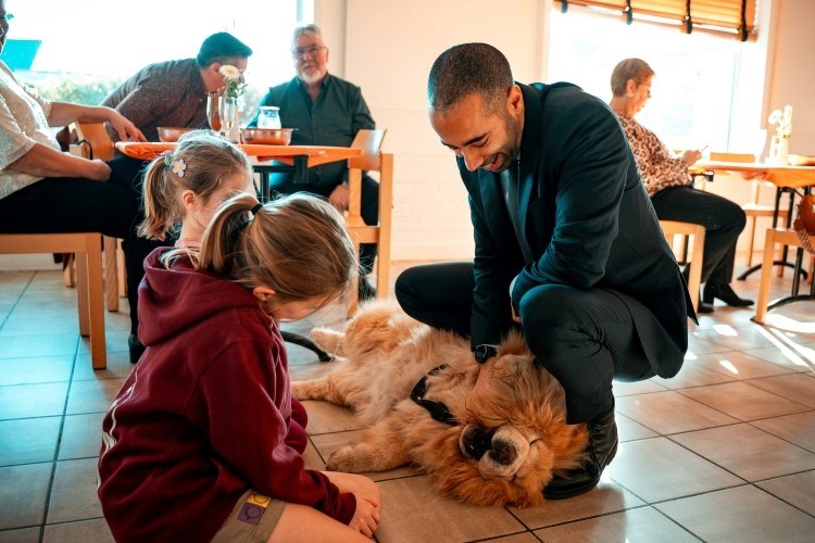 owner introducing his dog to kids