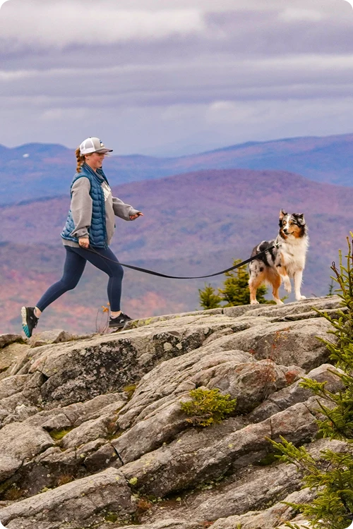 Woman hiking with her dog outdoors